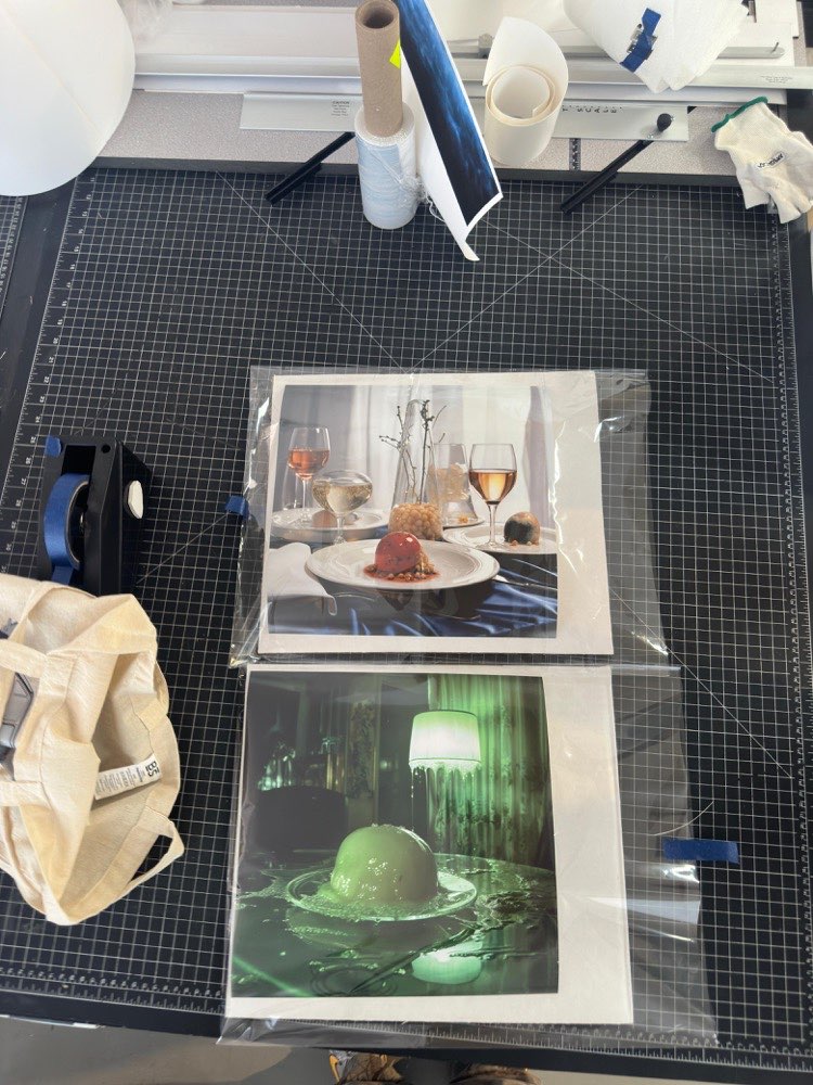 Two prints in protective sleeves on cutting mat, ready for the next production step